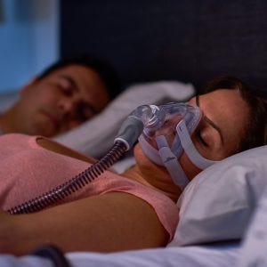 woman with allergies uses her backup CPAP mask