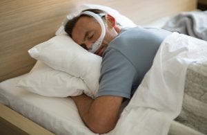 Man rests comfortably with backup CPAP mask