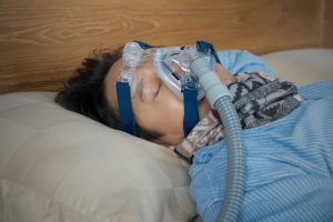 Man Uses CPAP for Sleep Apnea Therapy