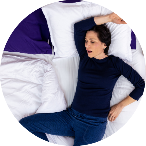 woman in bed snoring while sleeping
