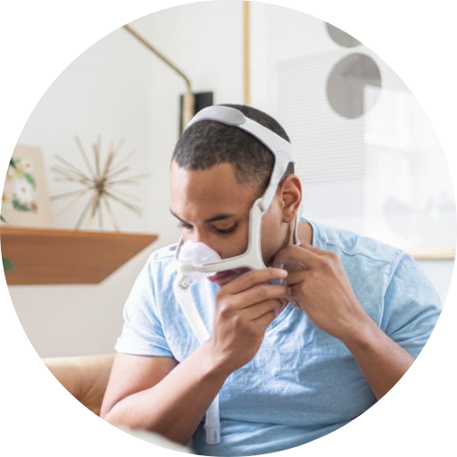 man trying on a nasal cpap mask to treat his sleep apnea