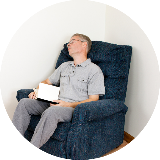 man sleeping in a recliner chair