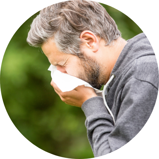man sneezing outside