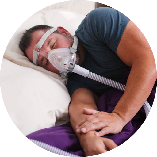 Man sleeping on his side during CPAP treatment wearing a full face CPAP mask