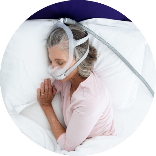 Woman sleeping wearing a full face CPAP mask