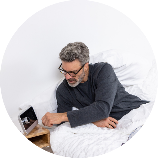 Man adjusting pressure settings on a CPAP machine for sleep apnea treatment