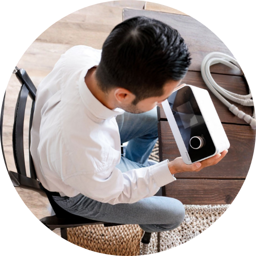 man looking at a cpap machine