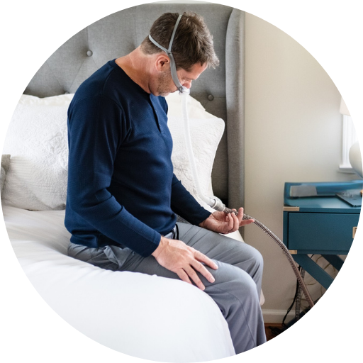 man looking at cpap tubing confused