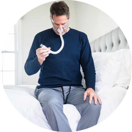 man looking at his cpap mask tubing
