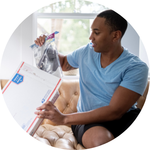 man opening a package containing a cpap mask