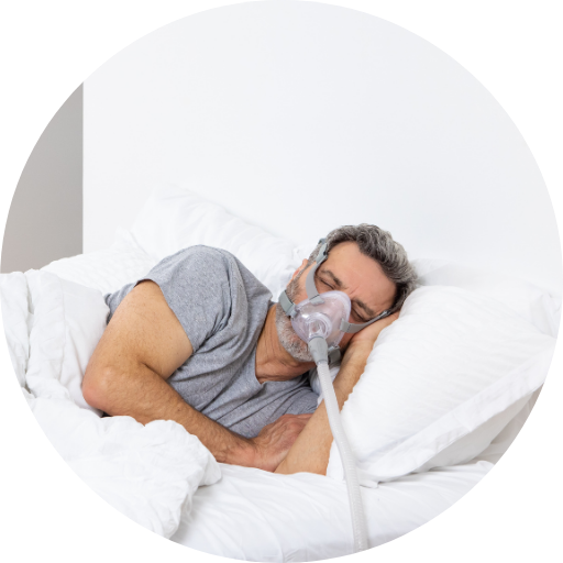 man sleeping on his side wearing a full face cpap mask