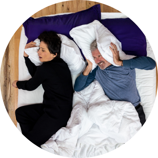 two people in bed with one snoring and the other struggling to sleep