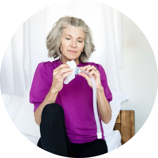person wiping their CPAP mask replacement cushion