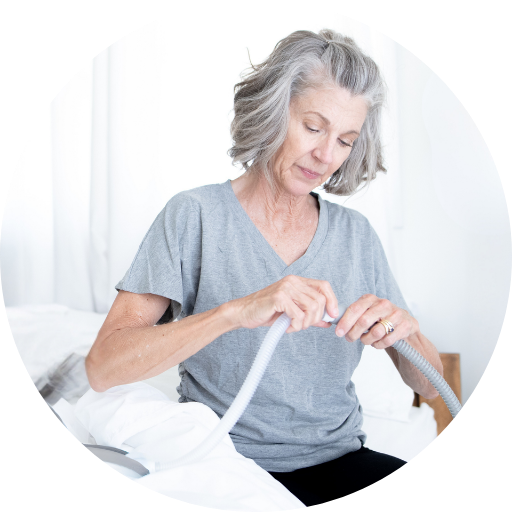 woman connecting and adjusting her cpap supplies