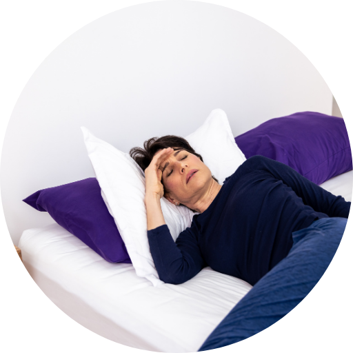 woman in bed struggling to sleep due to her obstructive sleep apnea