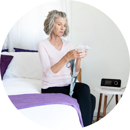 woman struggling to put together her cpap mask