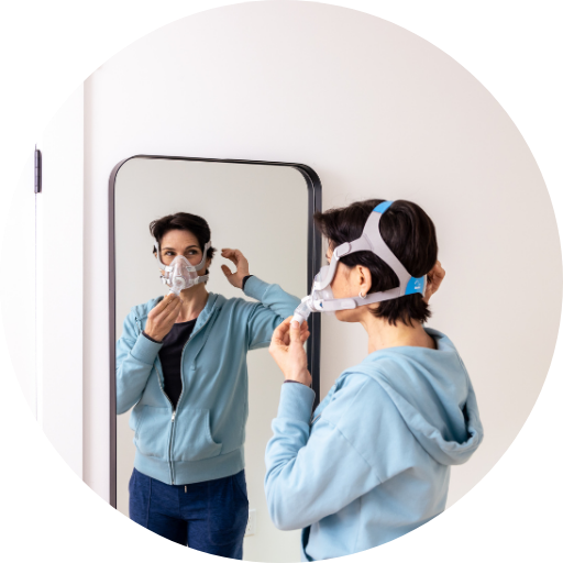 Woman trying on and fitting a full face cpap mask