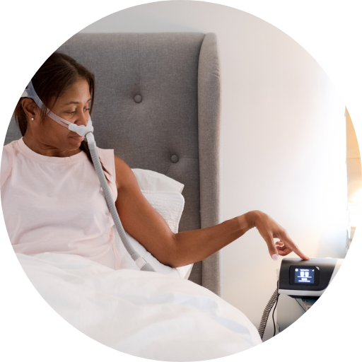 woman turning on a cpap machine